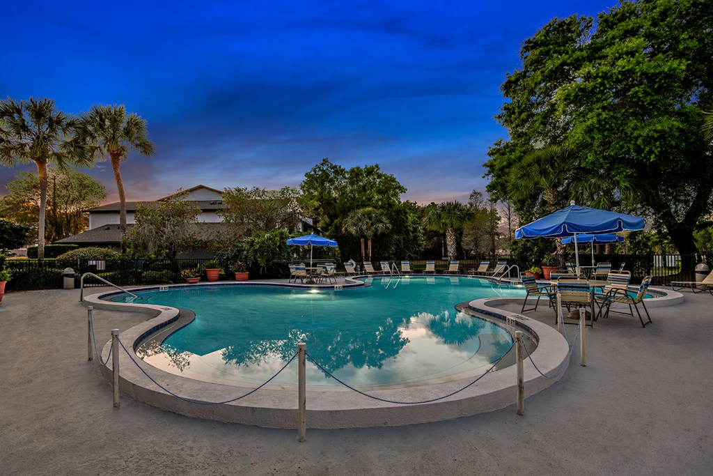 View of Brookside Manor Pool and Pool Deck with a dark blue sky