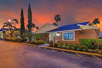 Park Avenue Apartments Tampa Florida Clubhouse Exterior with Trees and Sunset in Background