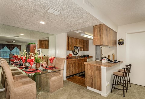 a kitchen and dining room with a table and chairs