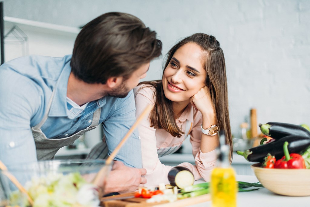 younger couple cooking together