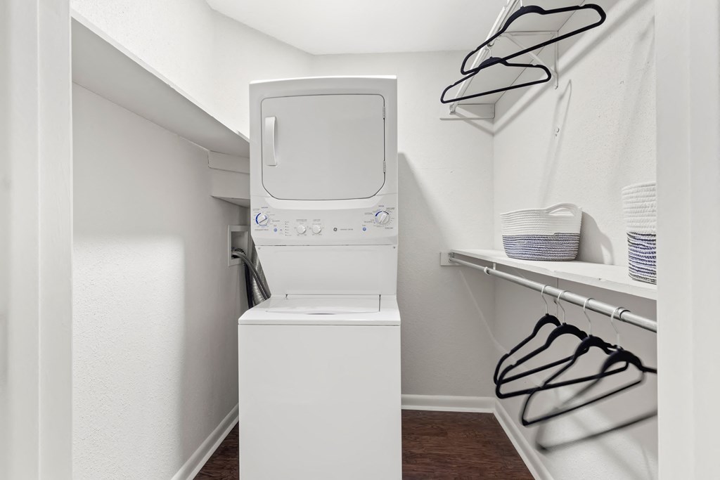 a white washer and dryer in a small laundry room with a dryer