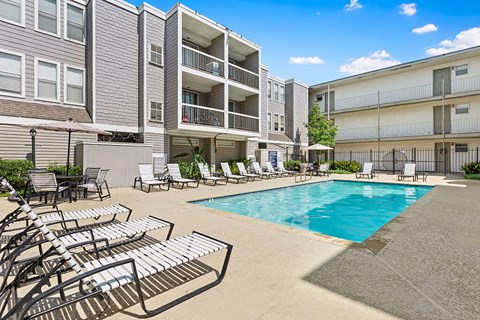 A pool area with sun loungers and a swimming pool.