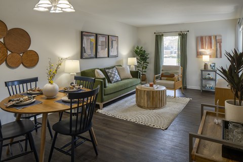 A living room with a dining table and chairs.