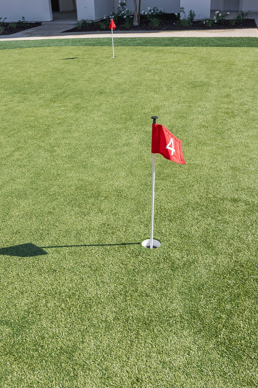 A red flag with the number 4 on it is stuck in the ground.