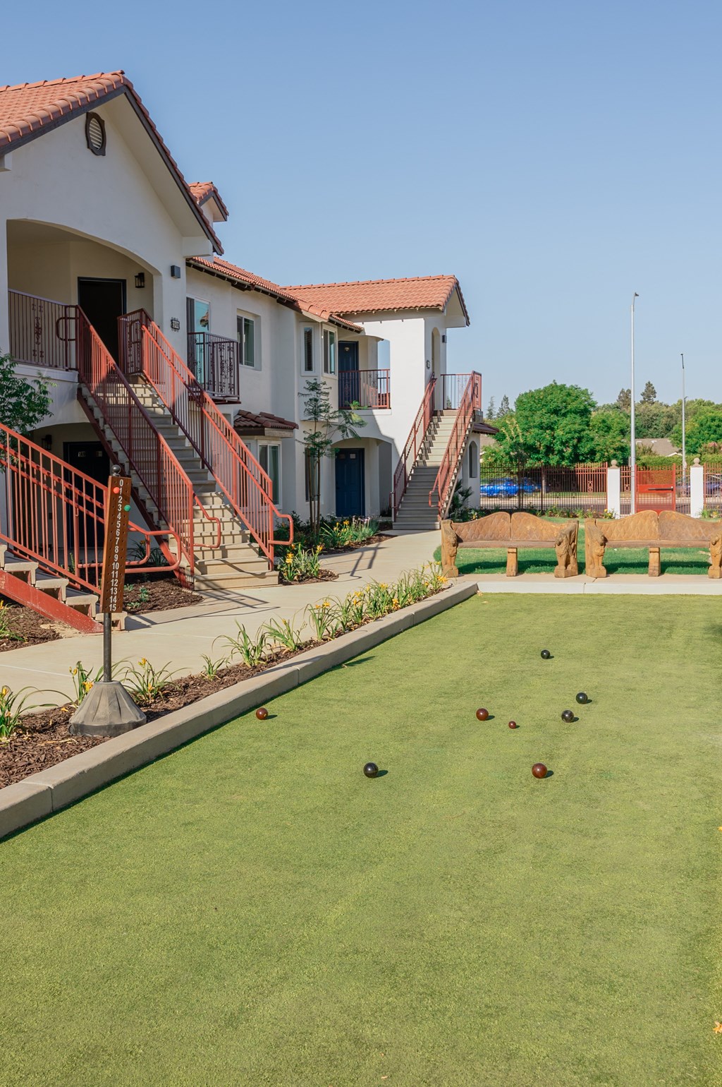 A Bocce ball lawn with a few balls on it at The Villas at Ellis Manor