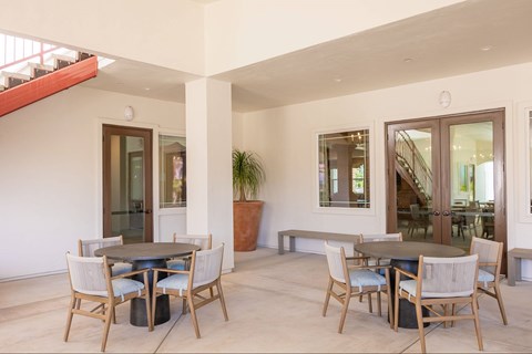 A dining room with a table and chairs.