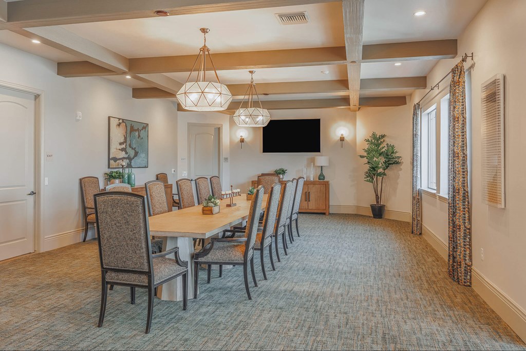 A large dining room with a long table and chairs.at The Villas at Ellis Manor, Fresno, CA 93720