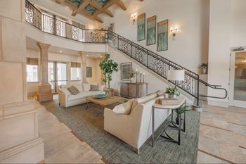 A living room with a staircase and a couch.at The Villas at Ellis Manor, California