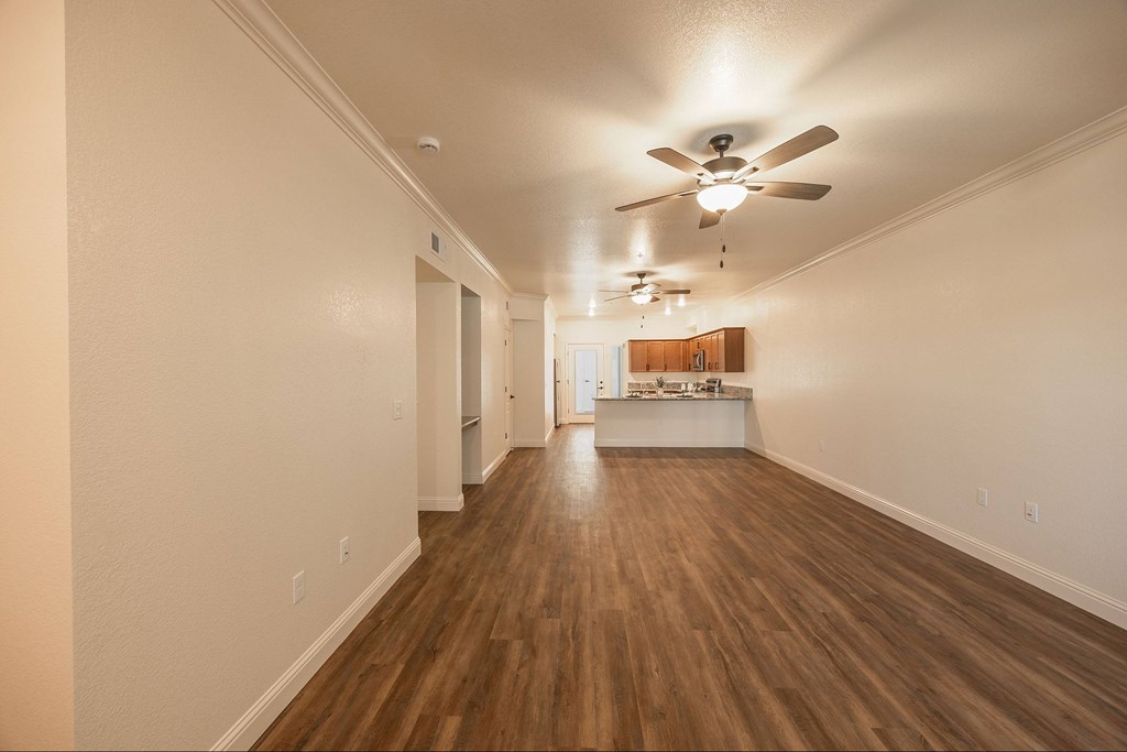 A long hallway with a ceiling fan and lighting.at The Villas at Ellis Manor, Fresno, CA 93720