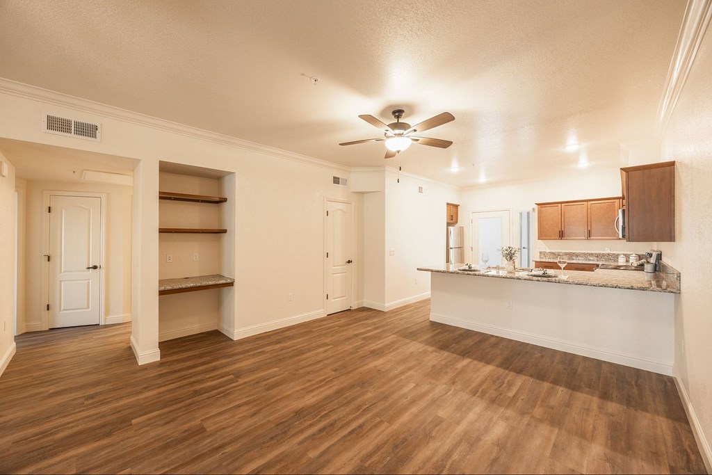 A room with a ceiling fan and wooden floors.at The Villas at Ellis Manor, Fresno, CA