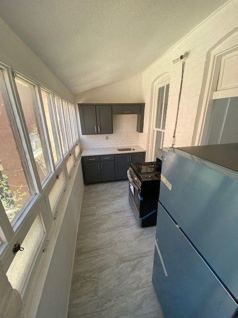 a small kitchen with a stove and a refrigerator