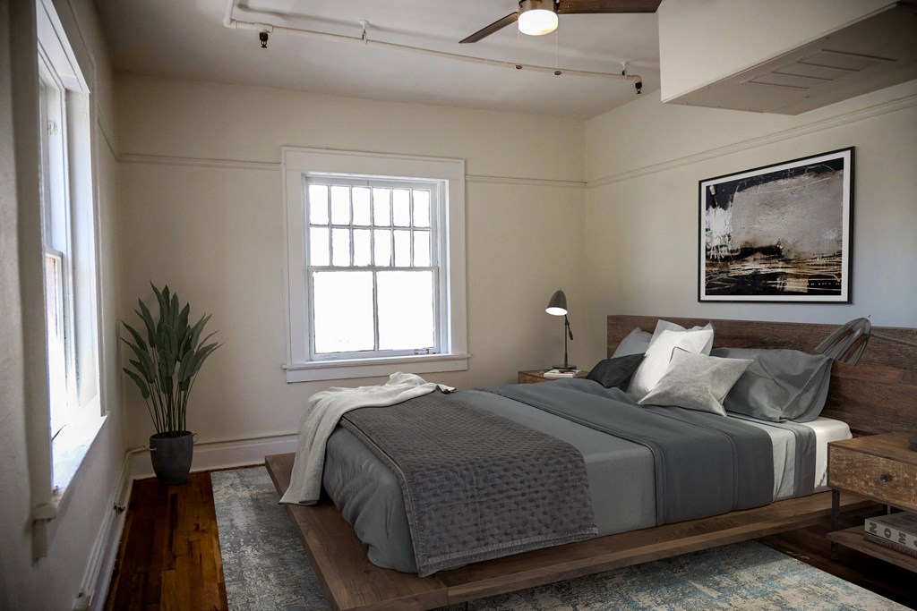 a bedroom with a bed and a painting on the wall