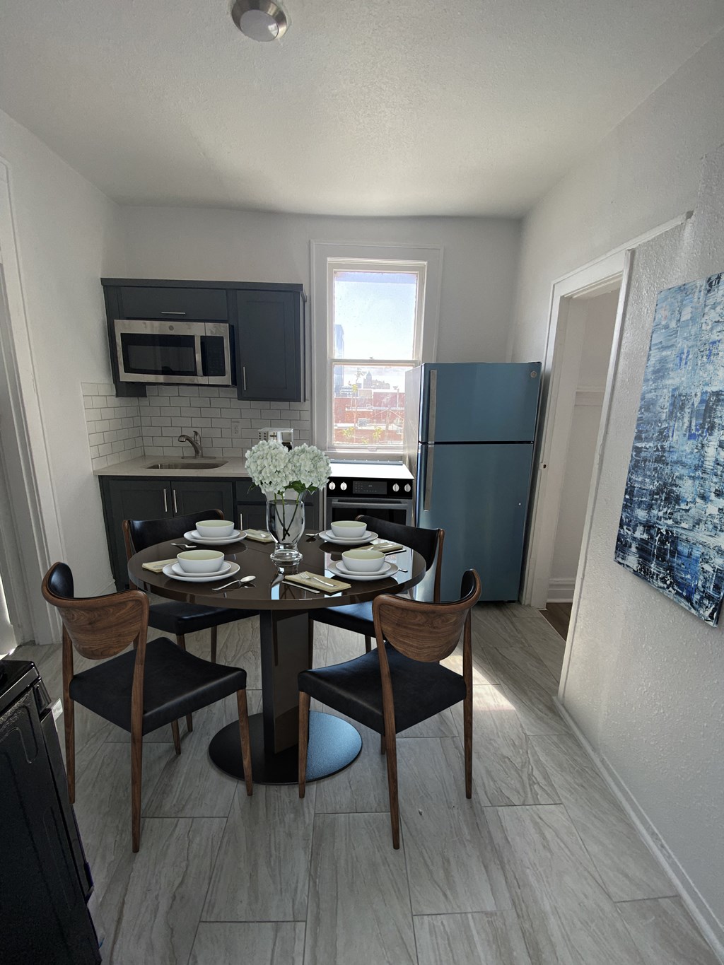 a kitchen and dining room with a table and chairs