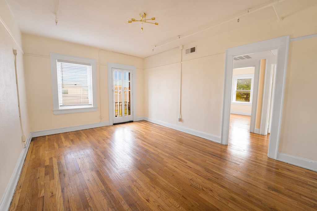 A room with wooden floors and white walls.