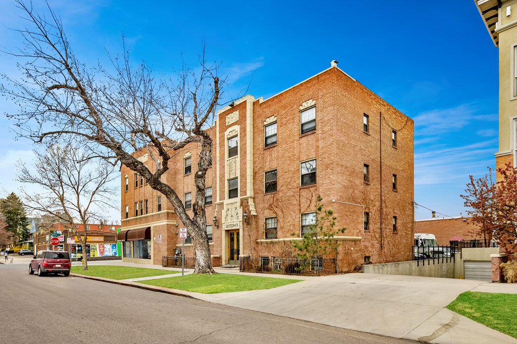 a red brick building with a street in front of it