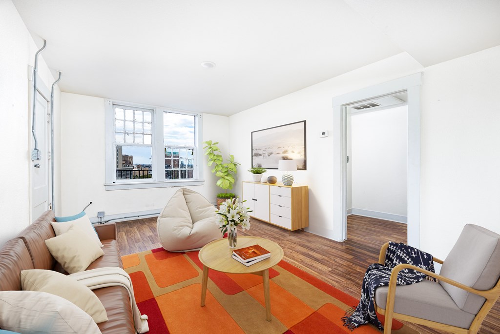 A living room with a brown couch, a coffee table, and a chair.