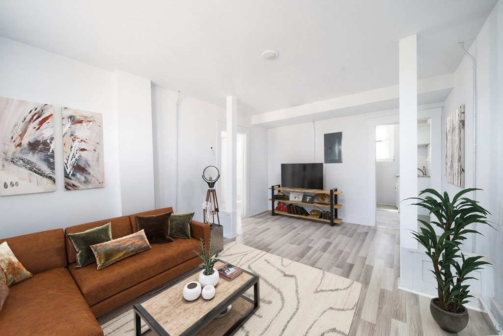 a living room with a brown couch and a coffee table