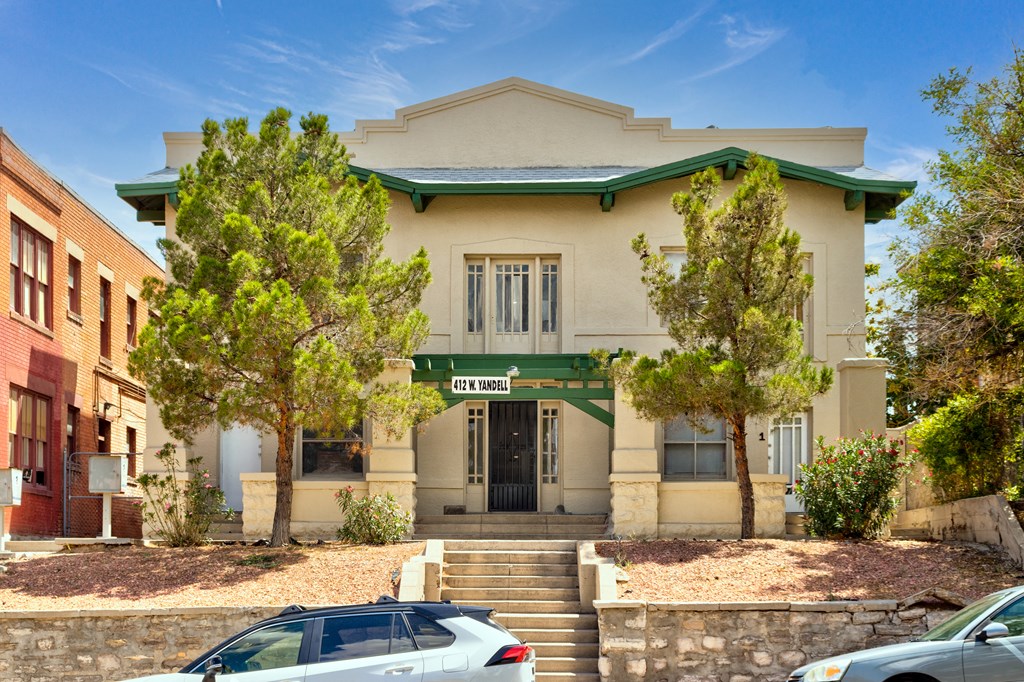 an old building with cars parked in front of it