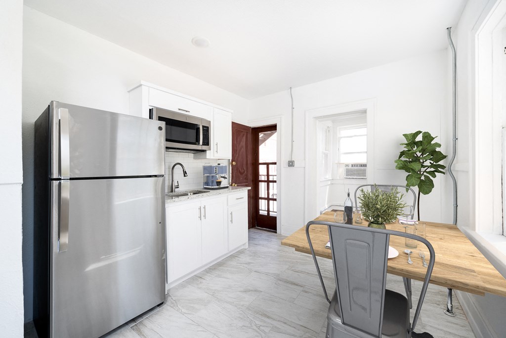 a kitchen with stainless steel appliances and a wooden table
