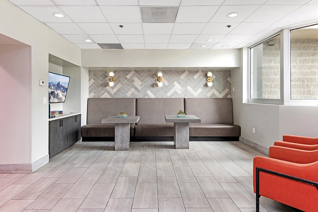a waiting room with couches and tables in a hospital