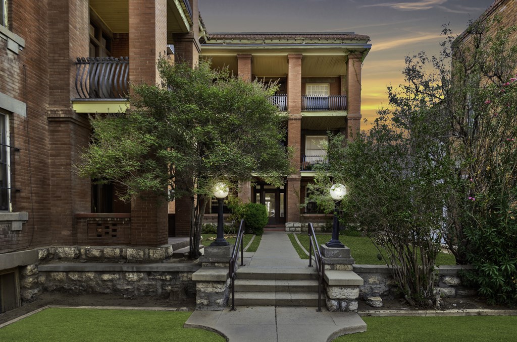 A building with a balcony and a staircase leading to it.