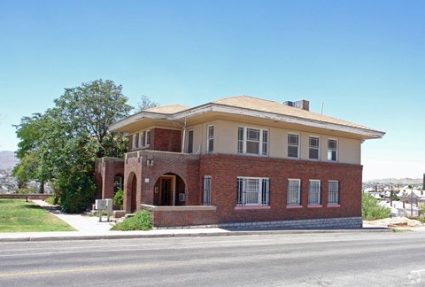 an old brick house on the corner of a street