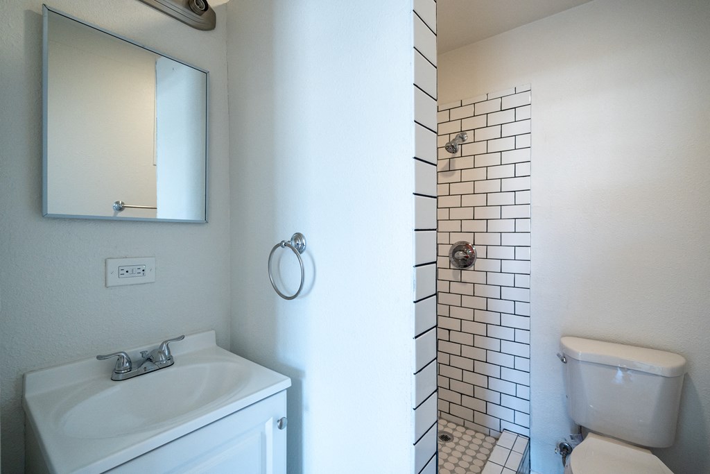 an empty bathroom with a sink toilet and shower
