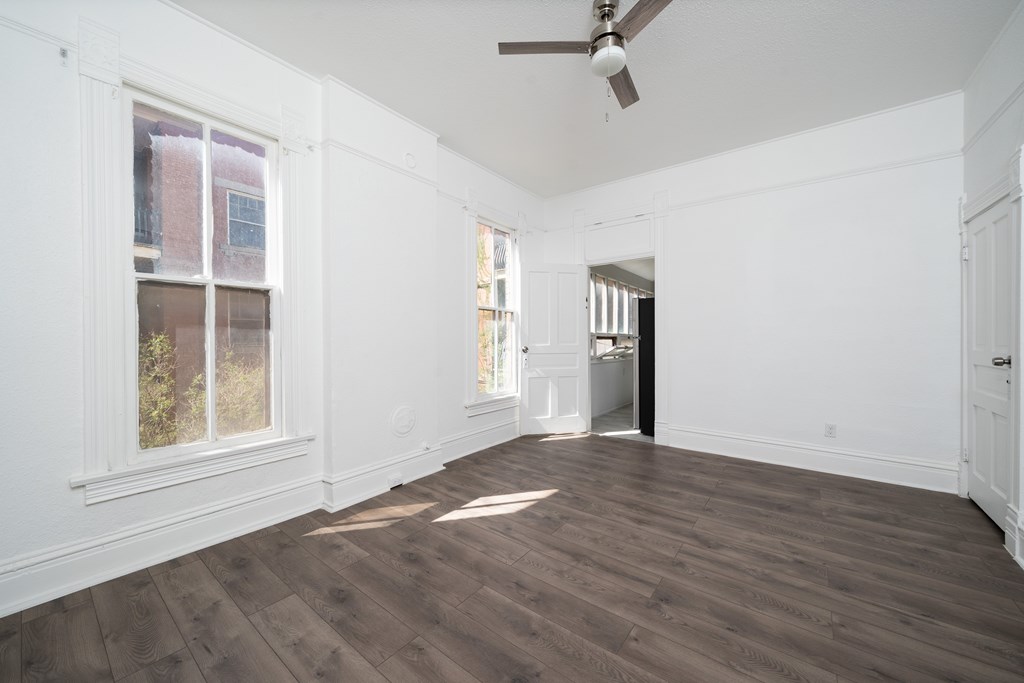 A room with wooden floors and white walls.