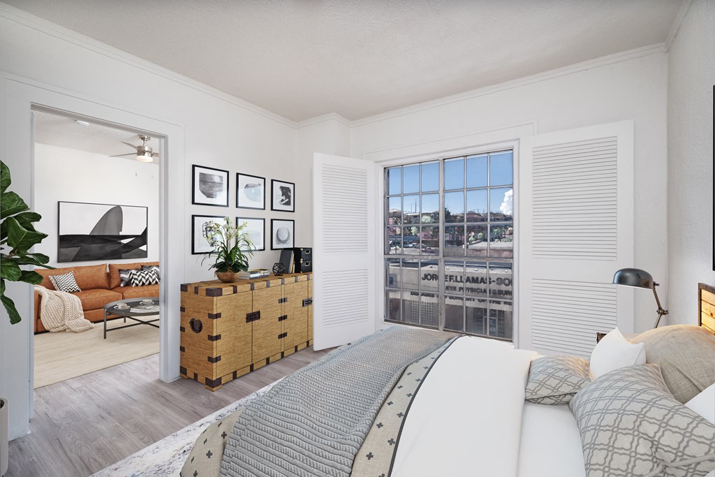 a bedroom with a bed and a large window