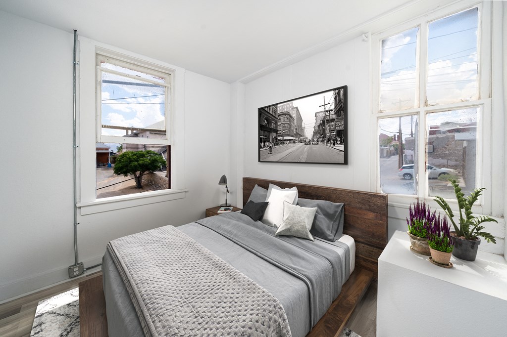 a bedroom with a large bed and a picture on the wall