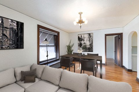a living room with a couch and a dining room table
