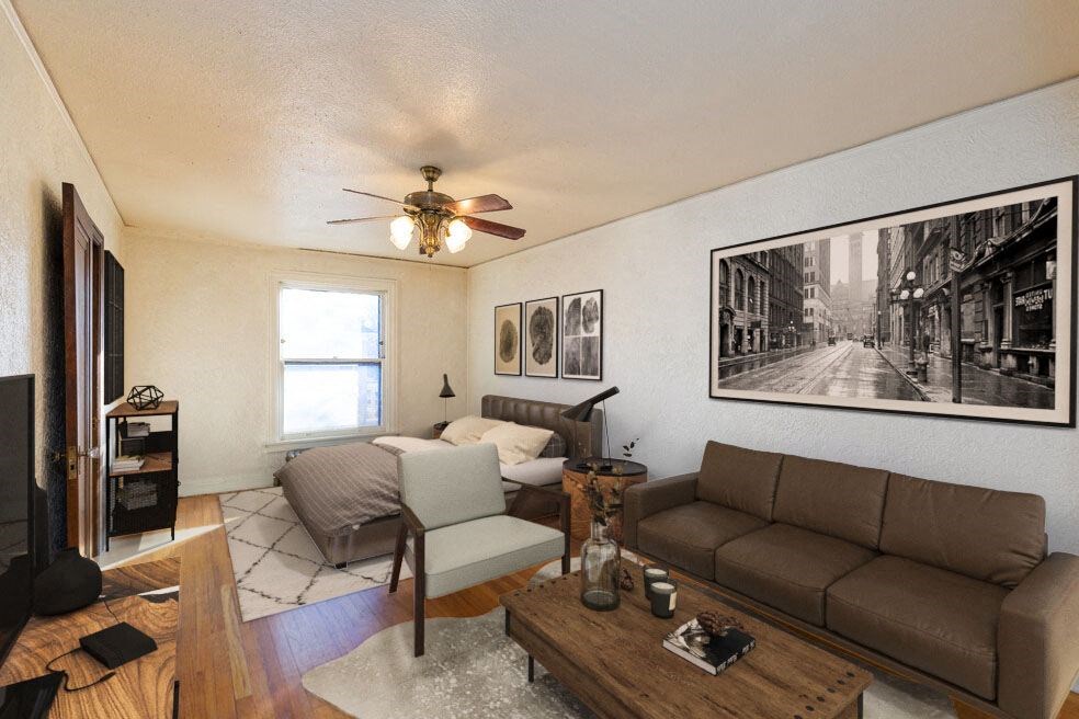 a living room with a couch and a ceiling fan
