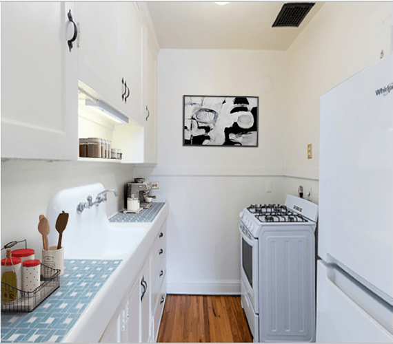 a kitchen with white cabinets and a white stove