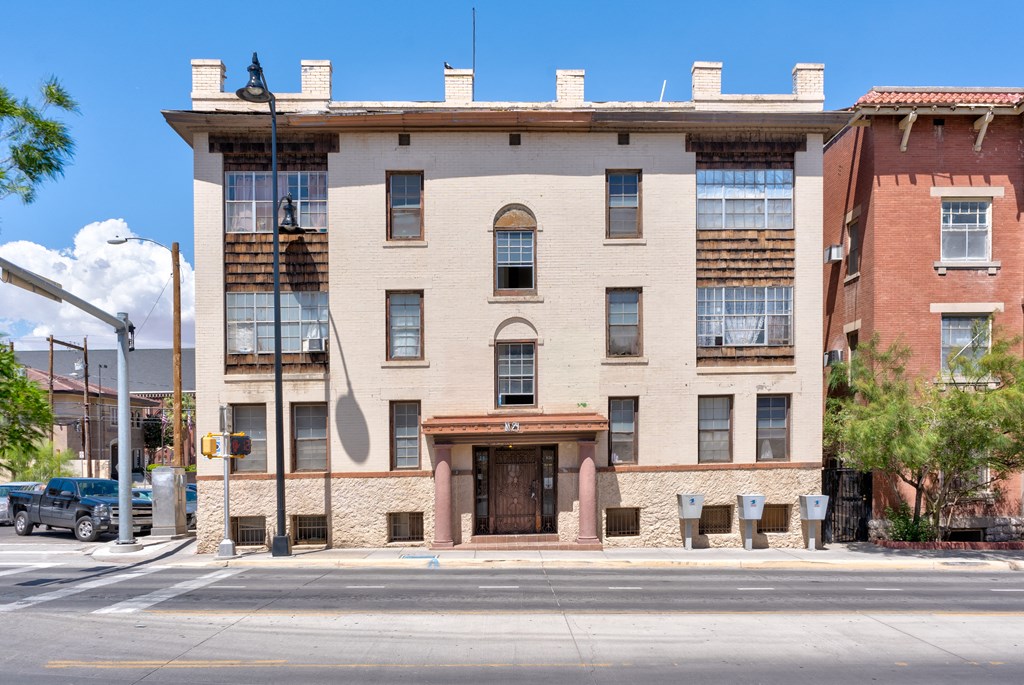 a large brick building with a wooden door on a street
