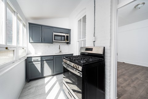 A modern kitchen with a black stove top oven.