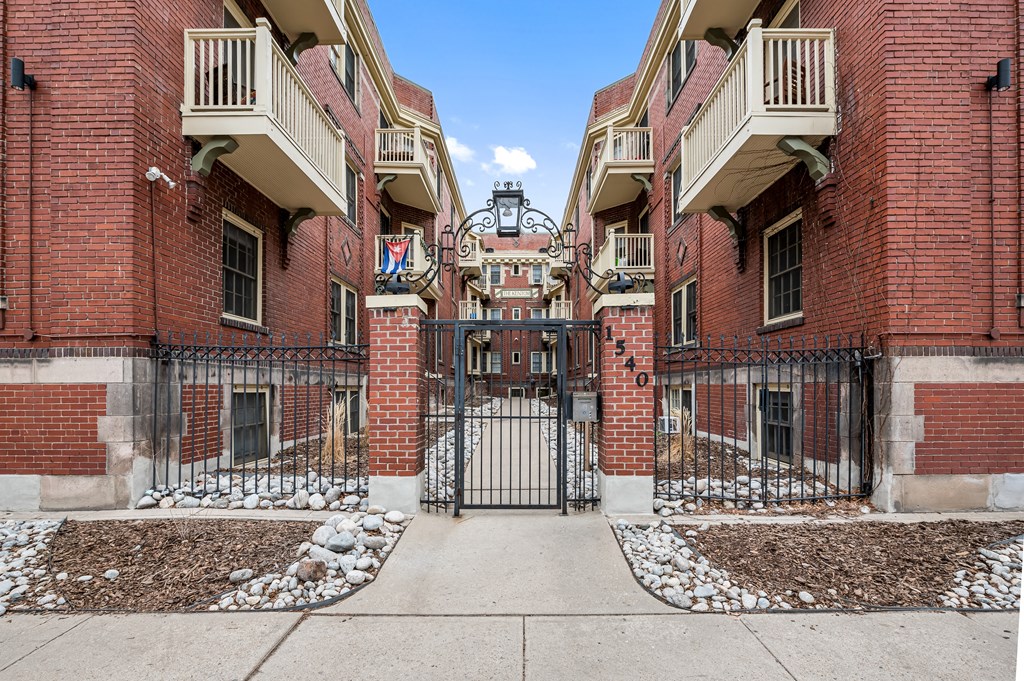 the entrance to a building with a wrought iron gate
