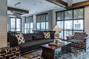 A living room with a grey couch and a wooden coffee table.
