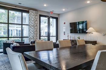 A conference room with a long table and chairs.