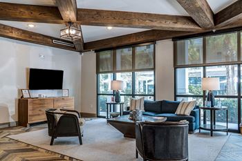 A living room with a large couch, a chair, and a coffee table.