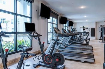 A gym with treadmills and exercise bikes.