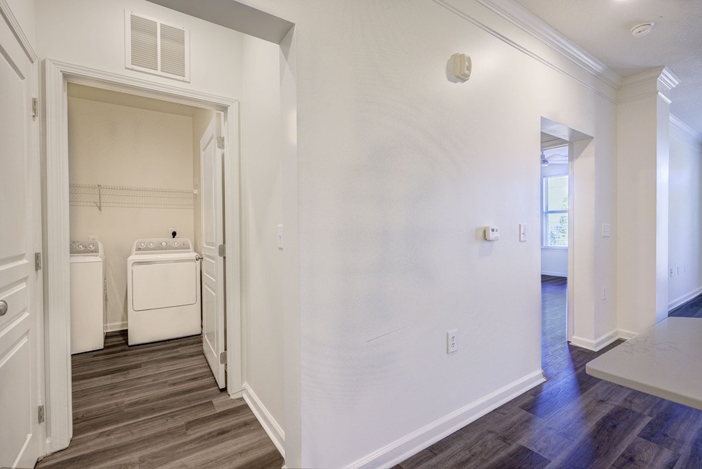 A laundry room with a washer and dryer in it.