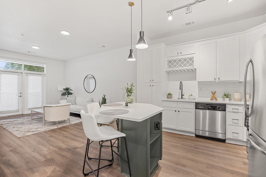 A modern kitchen with a dining table and chairs.