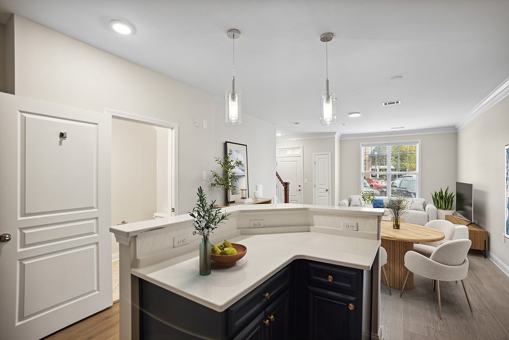 A modern kitchen with a dark blue counter and white cabinets.