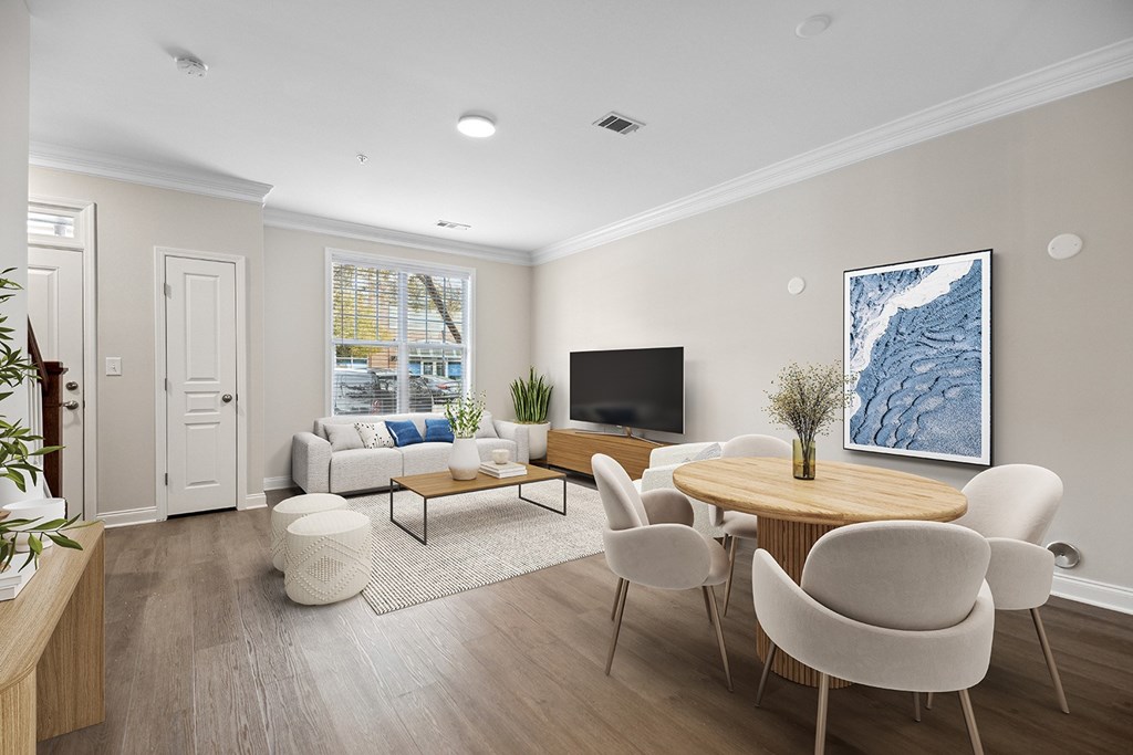 A living room with a white couch, a wooden coffee table, and a large painting on the wall.