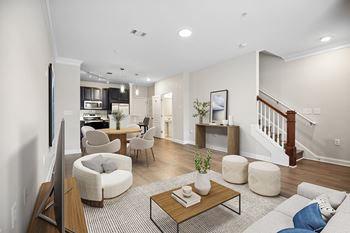 A living room with a couch, chairs, and a coffee table.
