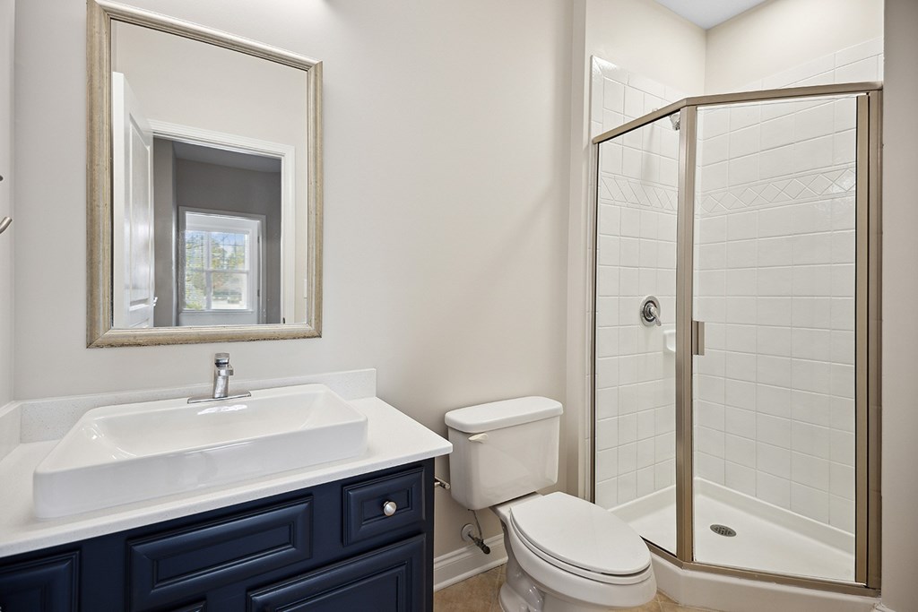 A bathroom with a white sink and a toilet.