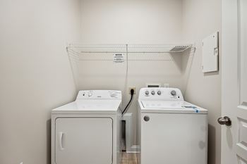 A white dryer and washer in a laundry room.