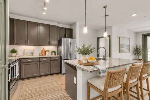 A kitchen with brown cabinets and a white island.