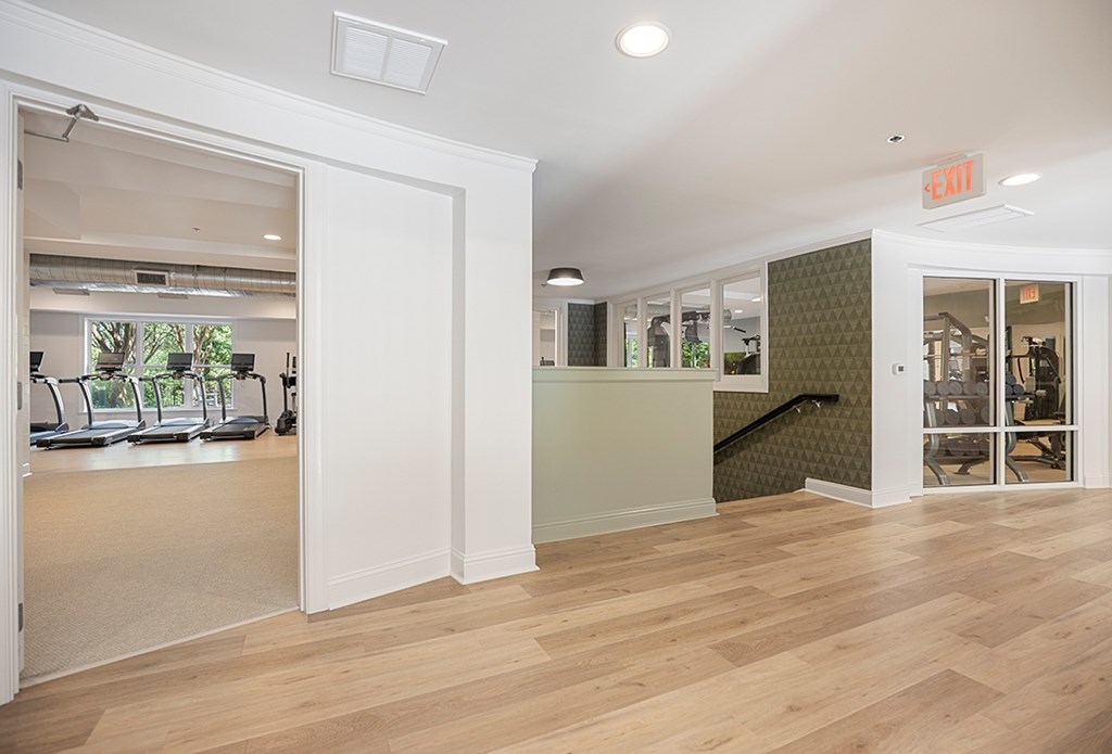 A room with a wooden floor and a green wall.