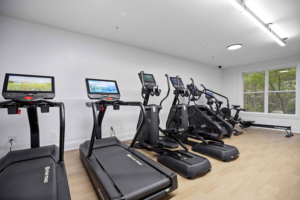 A gym with treadmills and elliptical machines.